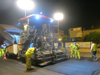 Spreading of the mix with sign in the background